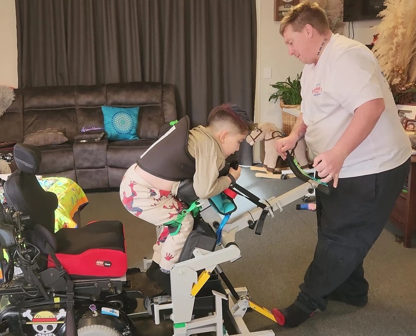 Odin, a child with muscular dystrophy, being transferred on the Kera sit2sit